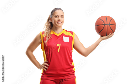 Female basketball player posing with a ball