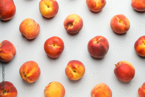 Many ripe peaches on light background