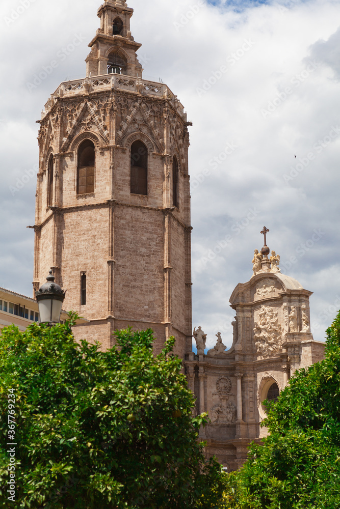 Metropolitan Basilica Cathedral of Saint Mary in Valencia with the bell tower El Miquelete. Plaza de la Reina. Spain.