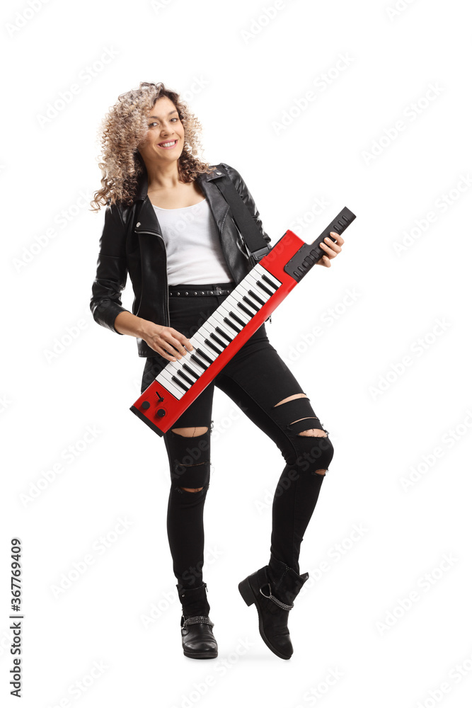 Full length portrait of a cool woman playing a keytar synthesizer and smiling Full length portrait of a cool woman playing a keytar synthesizer and smiling