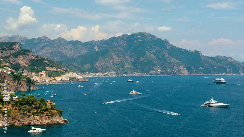 Slide right. Time lapse view from Conca dei Marini on Amalfi bay, Luxury boats traffic, fishing boats, tourist season. watercraft. Mountains and houses, buildings. Summer day in vacation. Italy Slide right. Time lapse view from Conca dei Marini on Amalfi bay, Luxury boats traffic, fishing boats, tourist season. watercraft. Mountains and houses, buildings. Summer day in vacation. Italy