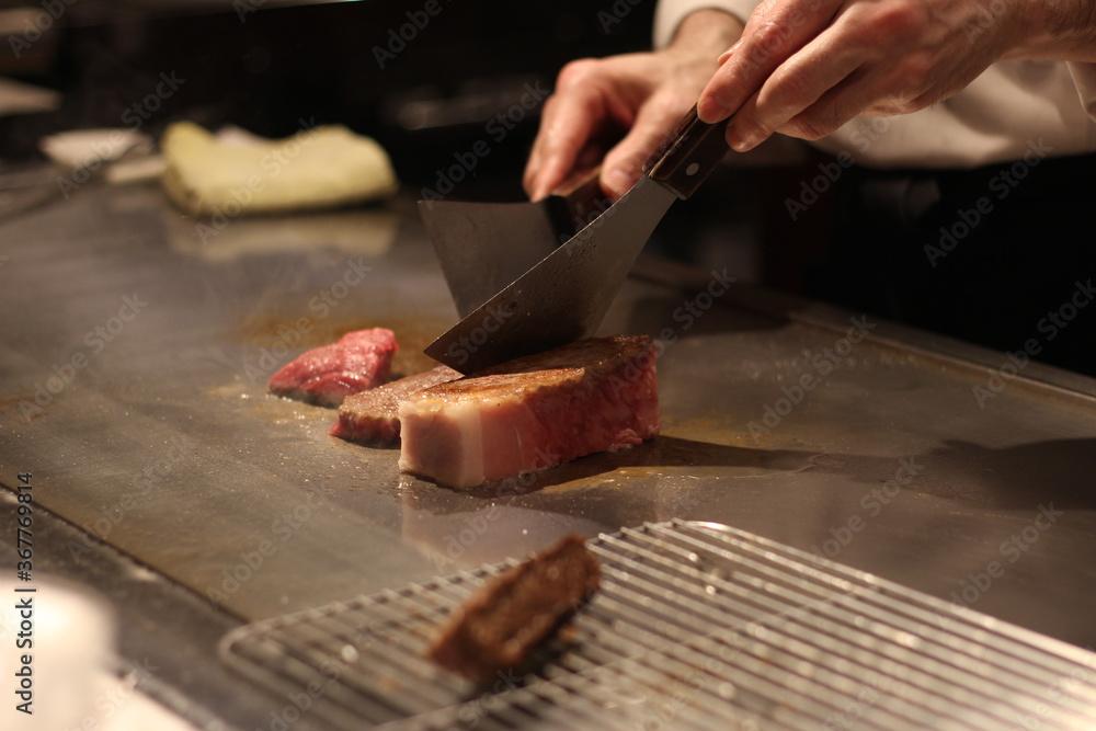 Close up of making a gourmet Kobe beef on a pan by a chef, Osaka, Japan, soft focus