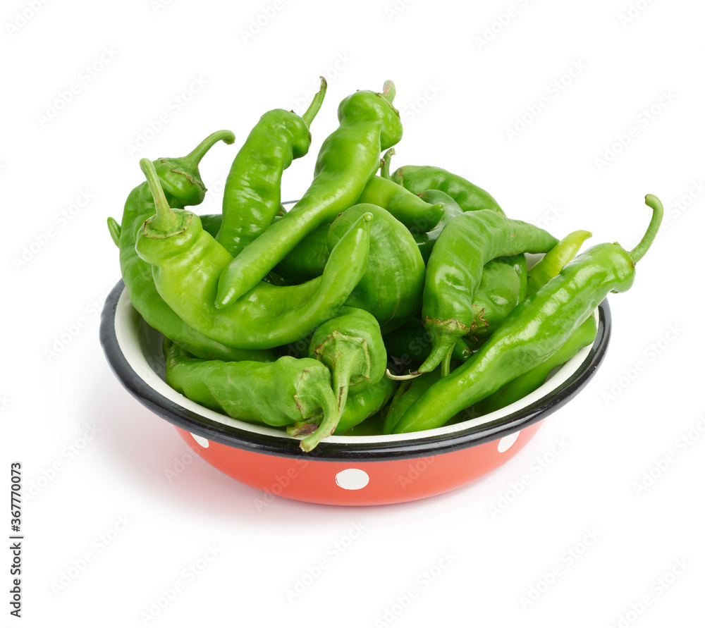 green hot pepper pods in red metal plate isolated on white background green hot pepper pods in red metal plate isolated on white background