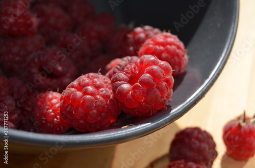 Sunny background with raspberries. Background with ripe berries.