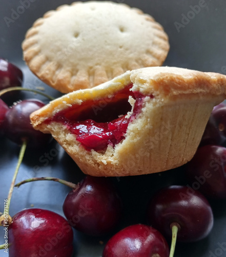 Cakes with cherries. Berries in a plate. Dessert.