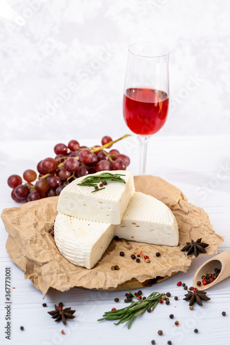 Homemade Adyghe cheese on a plate with spices