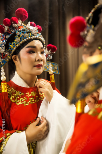 Asian Peking Opera and opera actor looking in the mirror