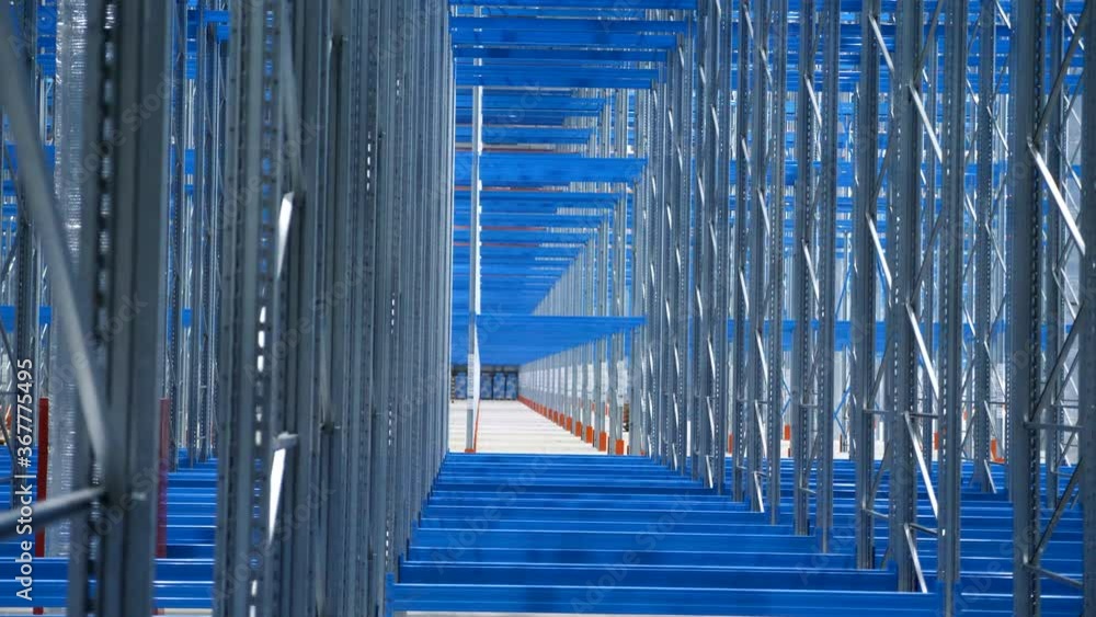 wide-view-empty-warehouse-with-metal-shelves-large-modern-industrial-building-from-the-inside