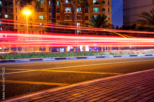 traffic in city with light trails from cars