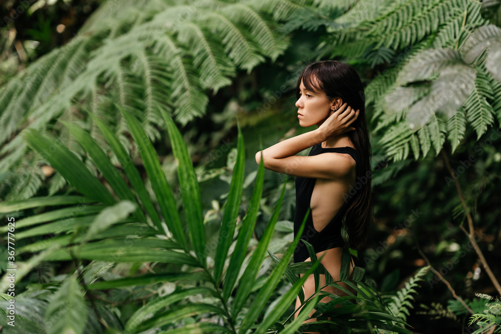 Attractive young woman among the tropical plants. Vacation. Tropics. Fashion shot. Attractive young woman among the tropical plants. Vacation. Tropics. Fashion shot.
