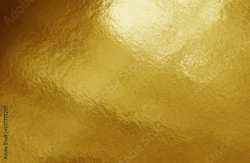 Gold foil background with highlights and uneven texture