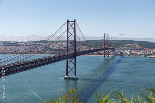Bridge on April 25 in Lisbon on the Tejo river with moving cars.