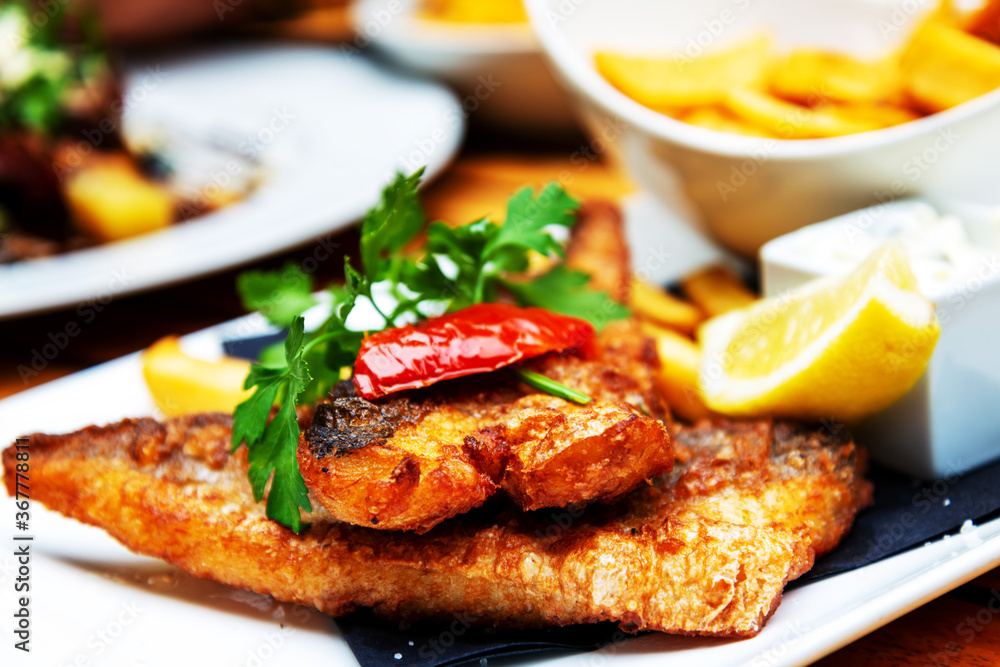 British Traditional fish and chips and tartar sauce British Traditional fish and chips and tartar sauce
