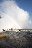 Beautiful rainbow over the famous Victoria Falls on the Zambezi River in South Africa. At the end of the rainy season, the waterfall most high water, Zambia, Zimbabwe, Africa