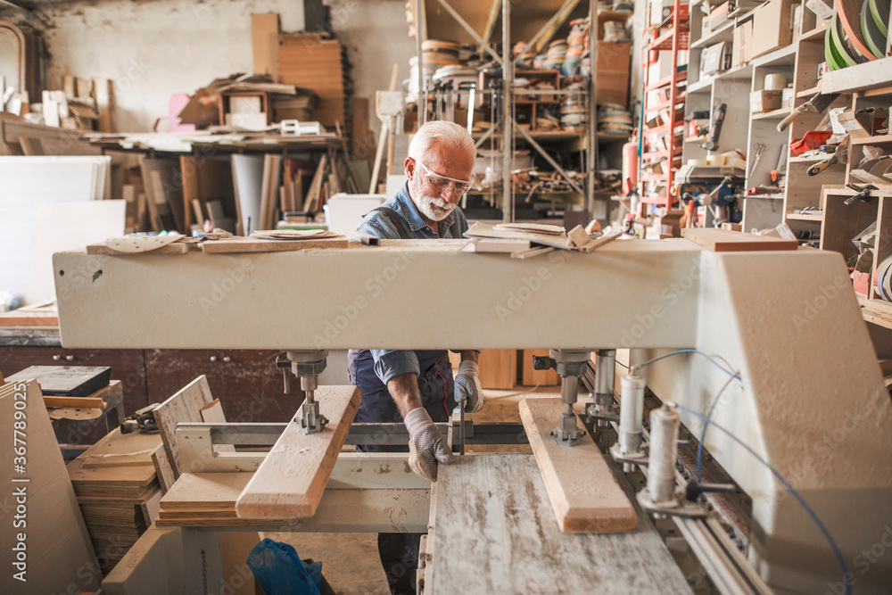 Joiner in a big carpentry workshop Joiner in a big carpentry workshop