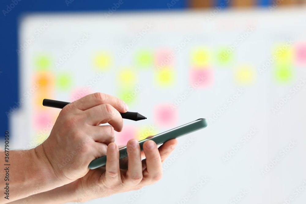 They hold smartphone and pen for electronic signature in their hand. Modern technologies and applications for mobile devices concept