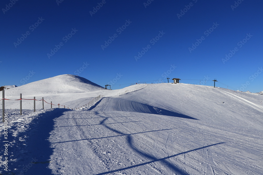 Fototapeta premium Ski resort of Obertilliach is located in the Lesachtal Valley, the southernmost part of East Tirol, and boasts not only snowsure slopes but also fabulous views of the Dolomites.