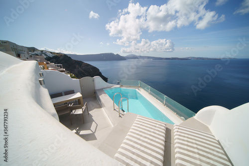 Beautiful pool villa landscape with sea view, white architecture on Santorini island, Greece.