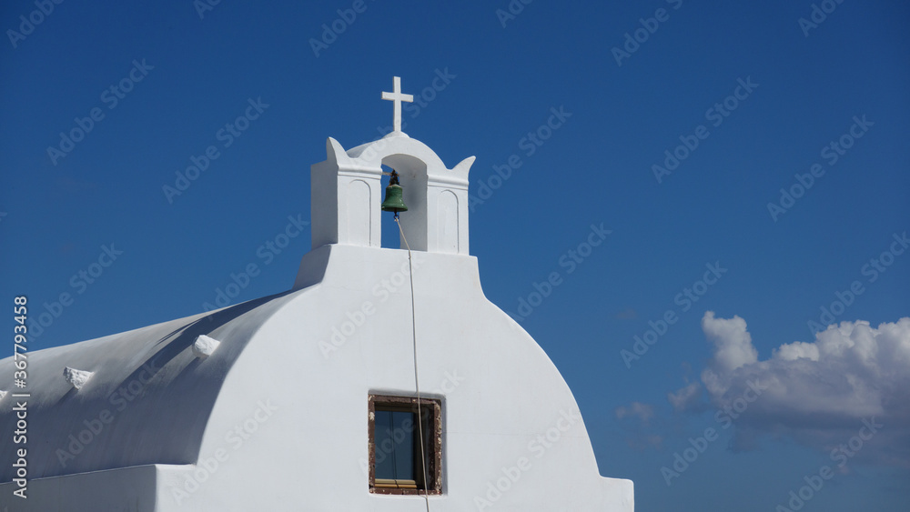 Close up of bell, white church in Oia Santorini, Greece.