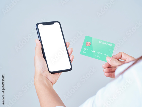 Woman with smartphone and credit card