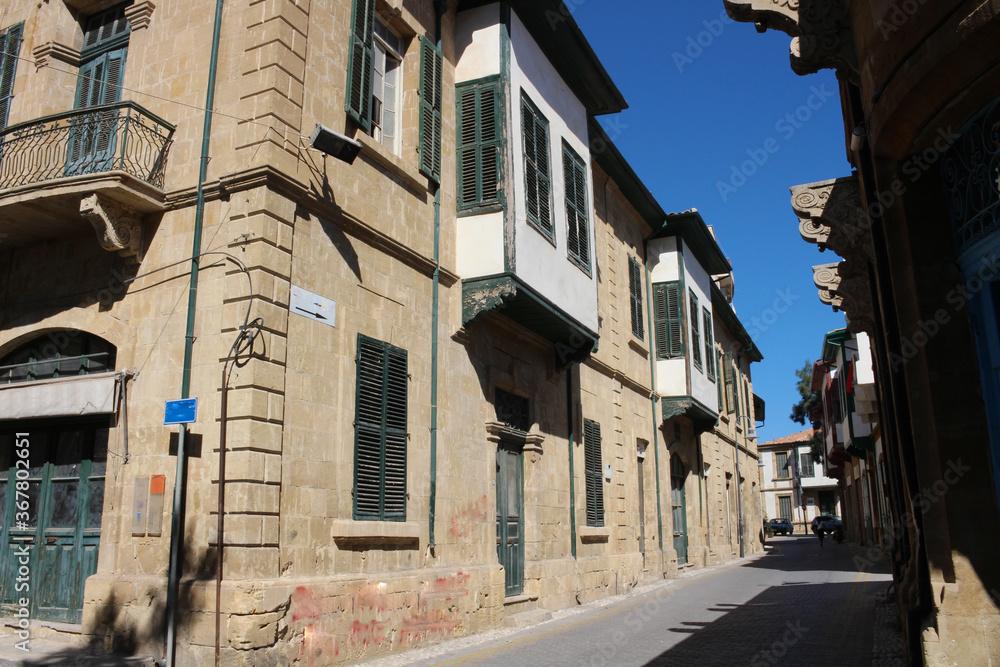 A house with green windows and doors on a street in Nicosia.