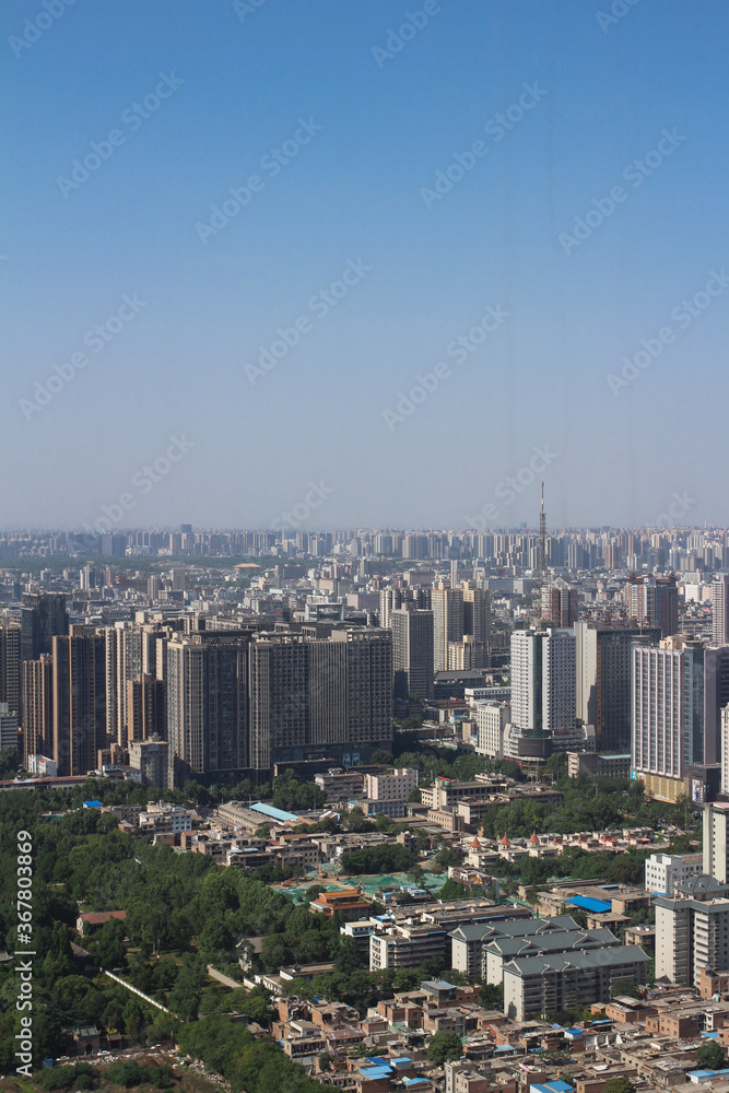 Obraz premium Top view of XI'an city.Panorama. Lots of high-rise buildings, demolition of old houses, a Park against the blue sky...
