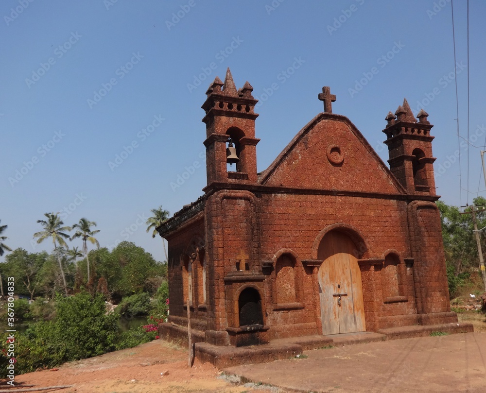 Closeup selective focus picture of Ancient Portuguese red church in Goa, India