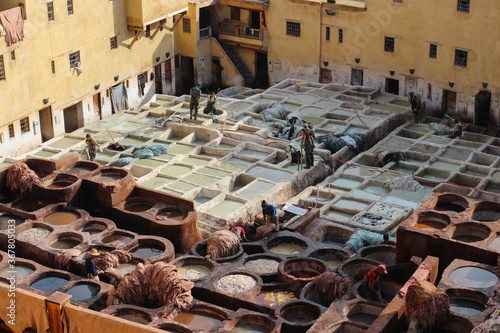 View from the observation deck on the process of processing animal skins in stone baths and preparing them for painting.