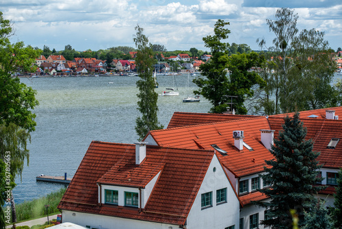 Fototapeta Naklejka Na Ścianę i Meble -  A view of sailboats, yachts, a lake, buildings in the Masurian town of Mikołajki
