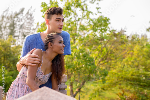 Portrait of young multi ethnic couple relaxing together at the park