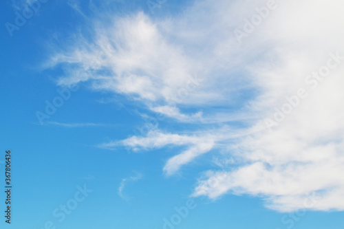 Blue sky on a sunny day, white clouds float by