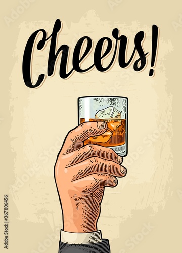 Male hand holding a glass with whiskey. Cheers calligraphy lettering