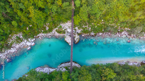 Aerial view of the turquoise blue Soca river (Isonzo) and wooden bridge near Bovec in the Julian Alps