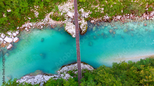 Quadro su tela Aerial view of the turquoise blue Soca river (Isonzo) and wooden bridge near Bov