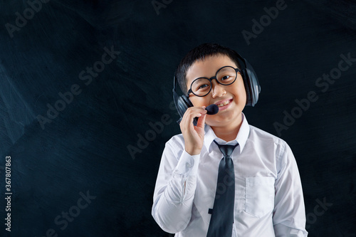 Little boy as call center operator smile at camera