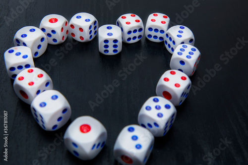 Many gaming dice shaped a heart symbol