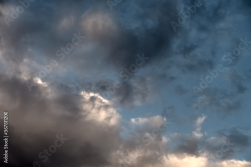 Storm clouds forming during monsoon season. .Dark clouds and dramatic sky...