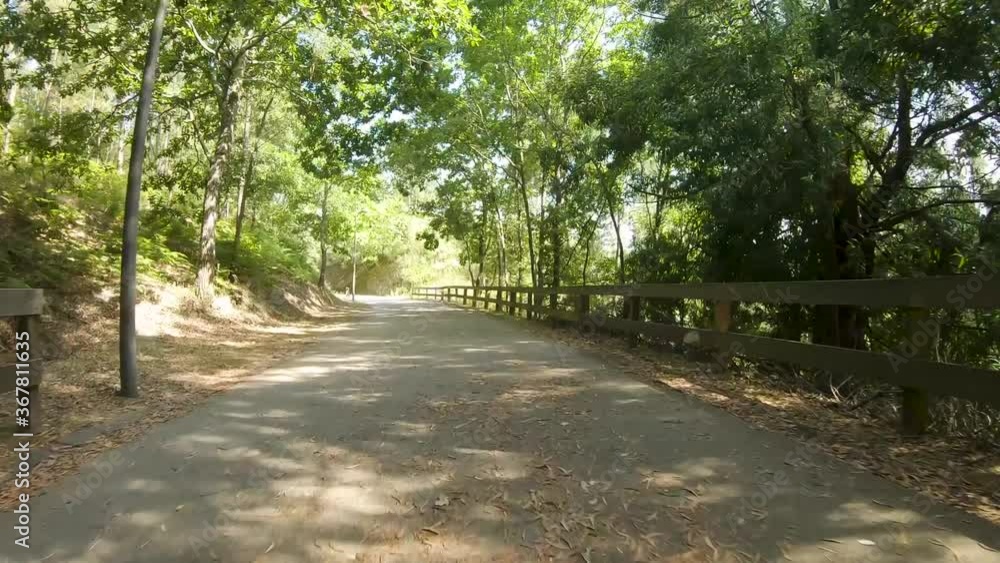 Point of view shot of riding a bicycle at Amarante Cycling Trail in Portugal. Features a wide view of the bike track and the natural scenery as it travels. Point of view shot of riding a bicycle at Amarante Cycling Trail in Portugal. Features a wide view of the bike track and the natural scenery as it travels.