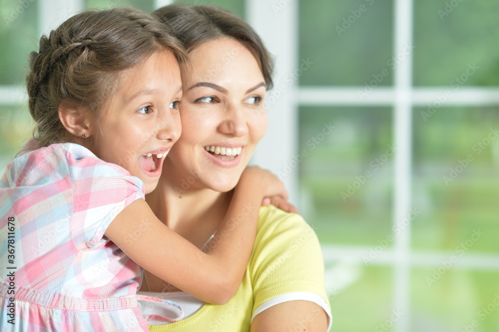 Portrait of a charming little girl hugging with mom at home Portrait of a charming little girl hugging with mom at home