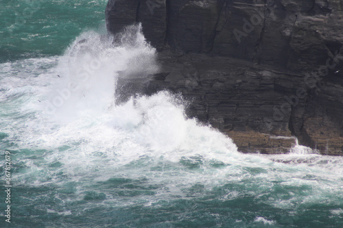 Waves crashing against the Cliffs of Moher, Ireland.