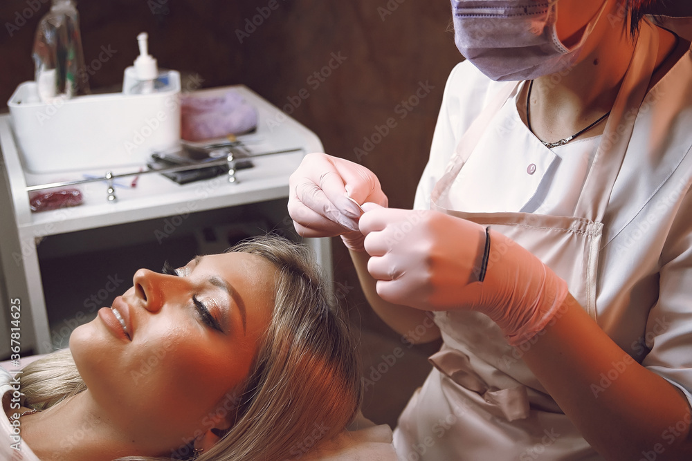 a woman does a procedure with a cosmetologist a woman does a procedure with a cosmetologist
