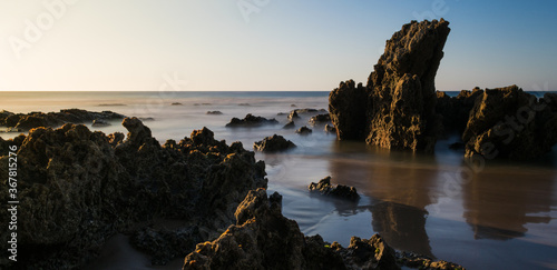 Rocks on the beach with blue horizon