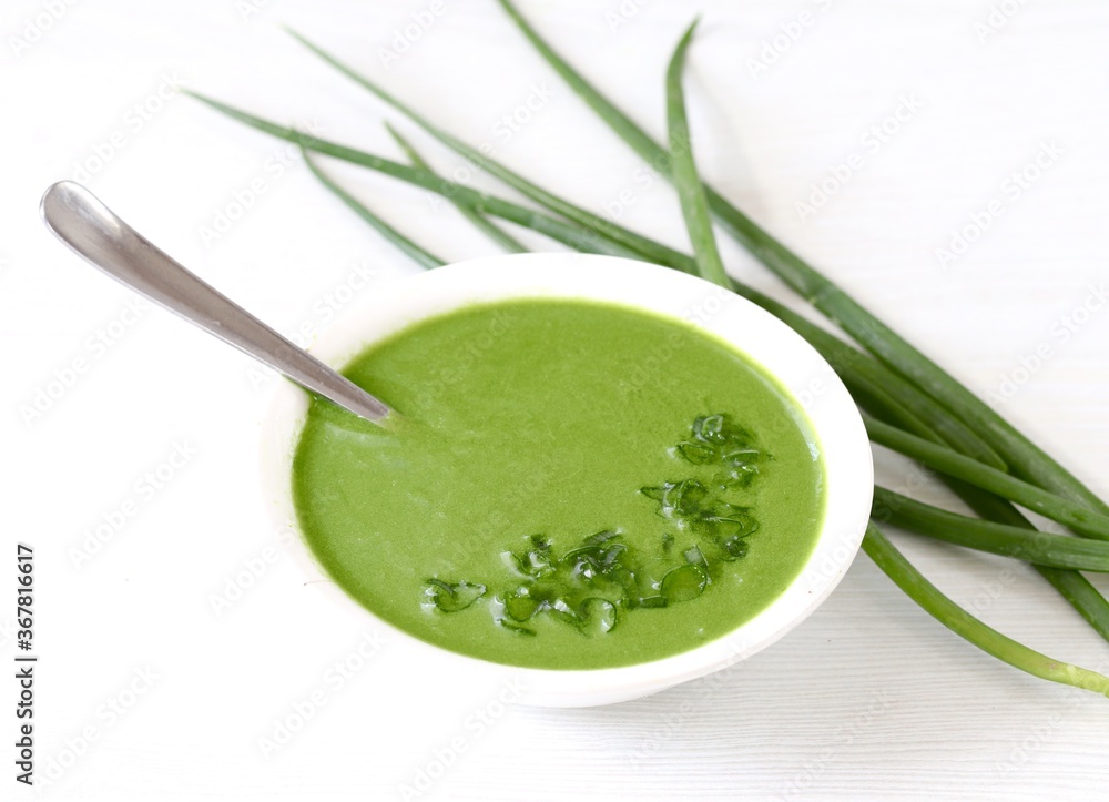 Green onion soup puree in a bowl on a white background Green onion soup puree in a bowl on a white background