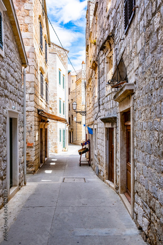 Komiza  Vis  Croatia  streets of Komiza town  Old stone houses in a charming narrow alley  typical Mediterranean architecture.