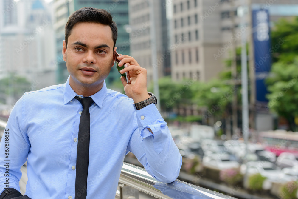 Young handsome Indian businessman in the city Young handsome Indian businessman in the city