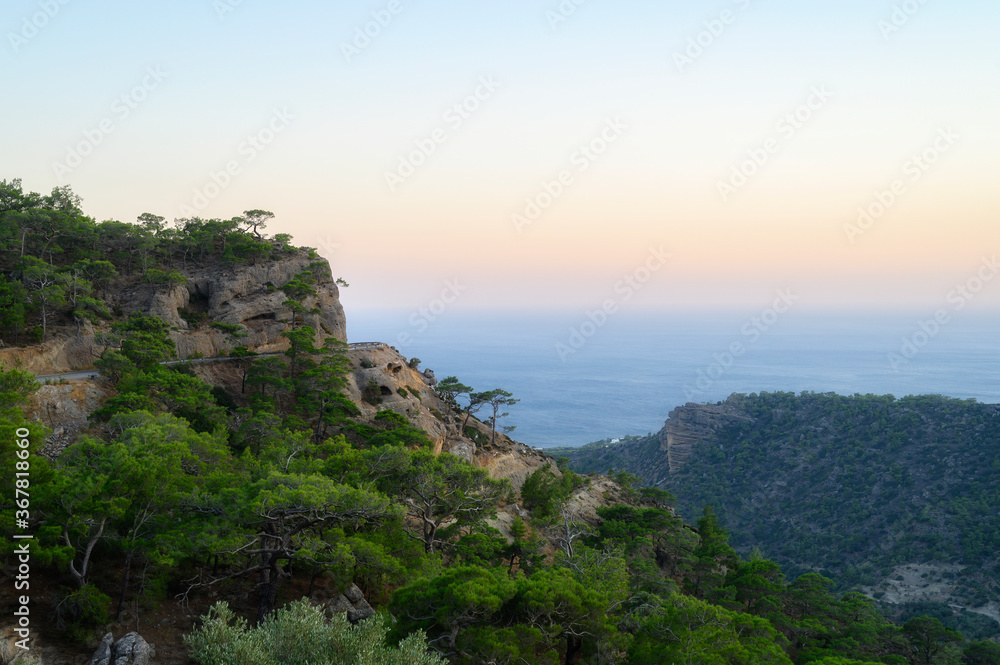dusk mountain landscape with views of the Mediterranean sea and cloudless sky. Golden hour, haze or fog dusk mountain landscape with views of the Mediterranean sea and cloudless sky. Golden hour, haze or fog