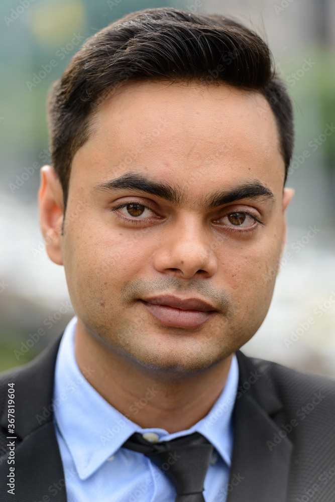 Young handsome Indian businessman in the city Young handsome Indian businessman in the city