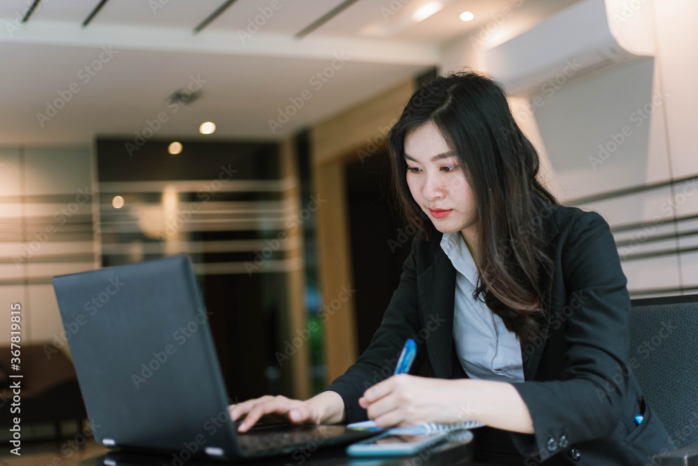 asian business woman using laptop computer in office asian business woman using laptop computer in office