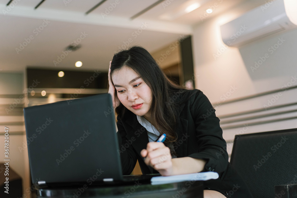 Beautiful young asian business woman with headache at office Beautiful young asian business woman with headache at office