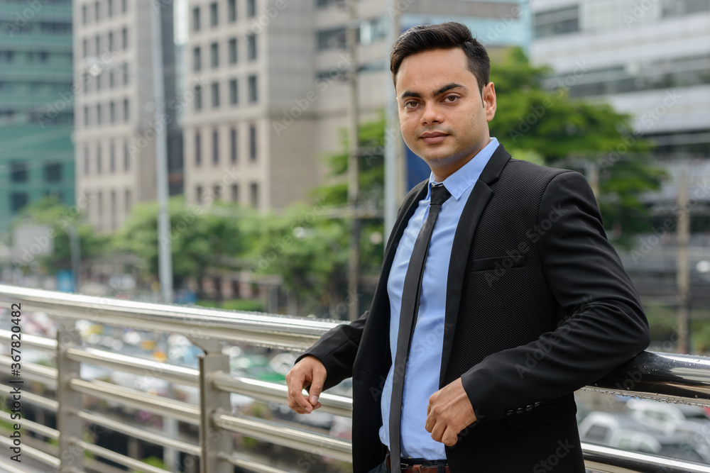 Young handsome Indian businessman in the city Young handsome Indian businessman in the city